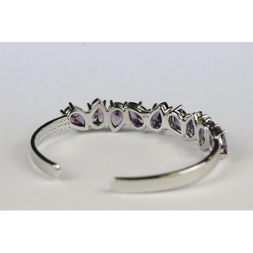 154 - A 925 sterling silver open cuff bangle set with nine tear drop amethyst stones, marked 925 to the ve... 