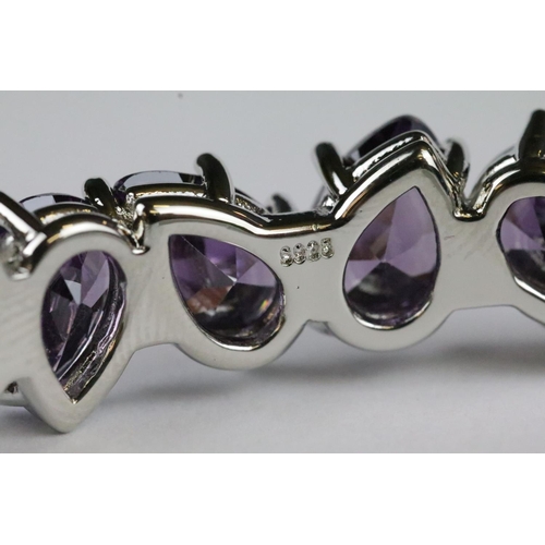 154 - A 925 sterling silver open cuff bangle set with nine tear drop amethyst stones, marked 925 to the ve... 