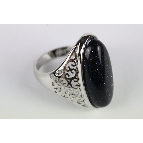 155 - A 925 sterling silver dress ring, central cabochon with decorative pierced shoulders, marked 925 to ... 