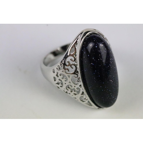 157 - A 925 sterling silver dress ring, central cabochon with decorative pierced shoulders, marked 925 to ... 