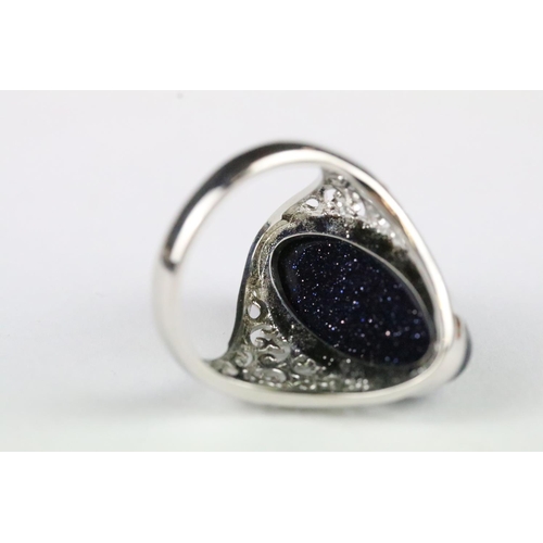 157 - A 925 sterling silver dress ring, central cabochon with decorative pierced shoulders, marked 925 to ... 