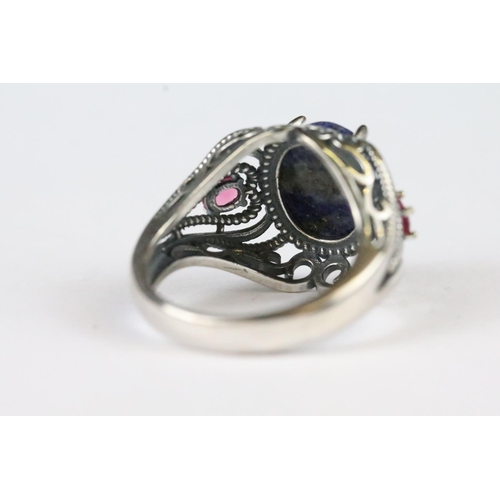 162 - A 925 sterling silver ladies dress ring with central blue stone and decorative shoulders.