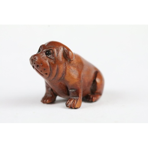 166 - Three carved wooden miniature netsuke figures to include signed Dog, Ox and Money Dragon