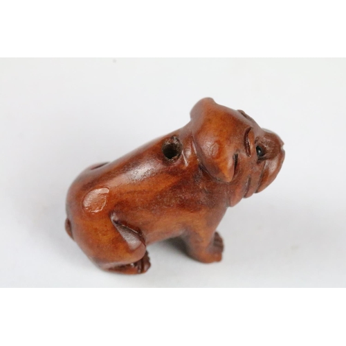 166 - Three carved wooden miniature netsuke figures to include signed Dog, Ox and Money Dragon