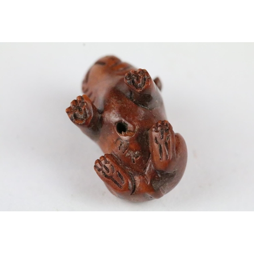 166 - Three carved wooden miniature netsuke figures to include signed Dog, Ox and Money Dragon