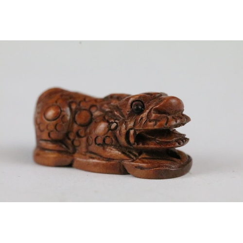 166 - Three carved wooden miniature netsuke figures to include signed Dog, Ox and Money Dragon