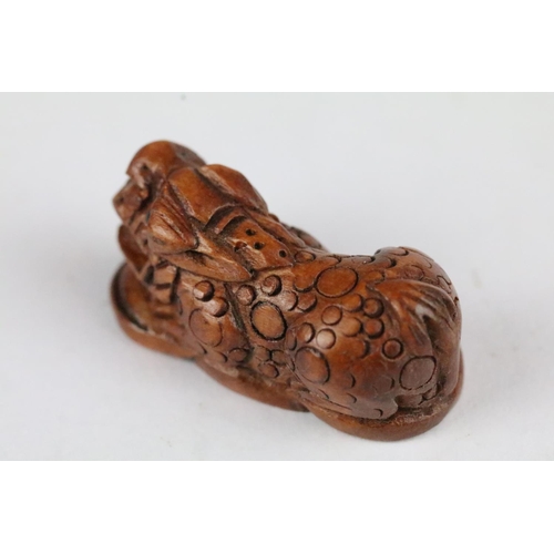 166 - Three carved wooden miniature netsuke figures to include signed Dog, Ox and Money Dragon