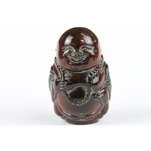 168 - Three carved netsuke toggles to include a Happy Buddha, Koi Fish and Buddha head, largest measures 7... 