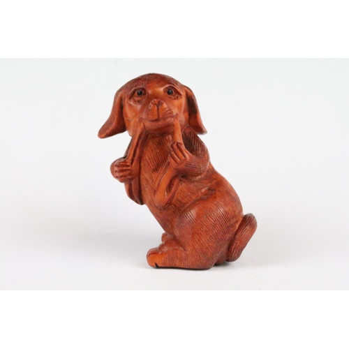 170 - Two carved wooden netsuke figures to include a signed Dog chewing toy, and a Money Dragon on Coin, t... 