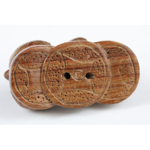 170 - Two carved wooden netsuke figures to include a signed Dog chewing toy, and a Money Dragon on Coin, t... 