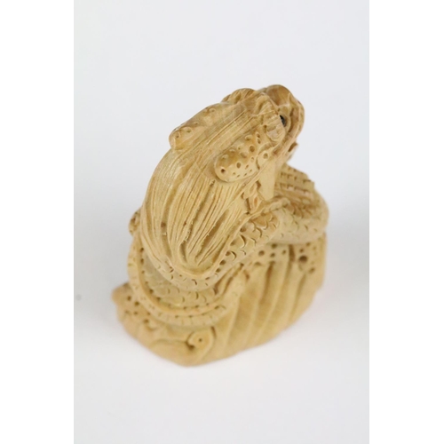 179 - Two carved wooden netsuke figures in the form of dragons, 5cm approx