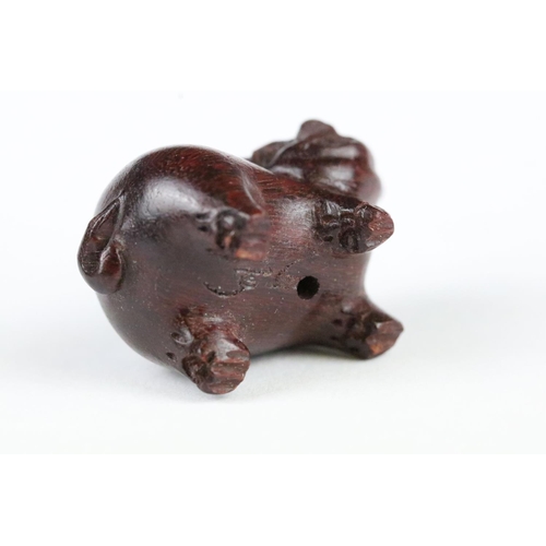 181 - Three carved wooden miniature netsuke figures to include signed Pig, Money Goat and a Dragon