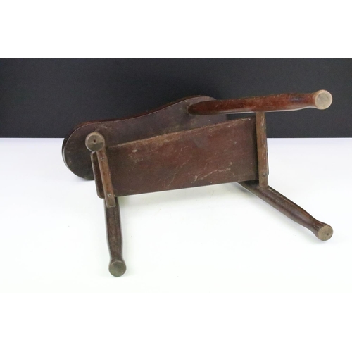 200 - A vintage wooden shoe shiners footrest with lower shelf, stands approx 40cm in height.