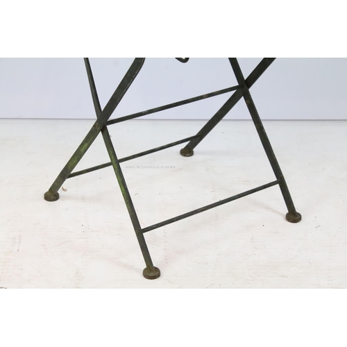 201 - A rustic wrought iron garden chair with mesh seat together with a glass topped table.