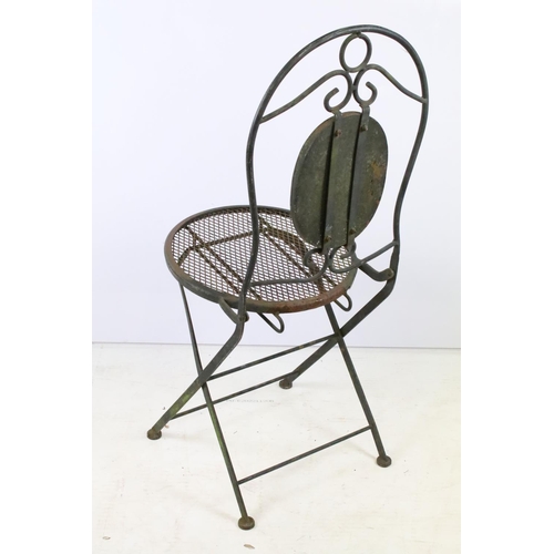 201 - A rustic wrought iron garden chair with mesh seat together with a glass topped table.