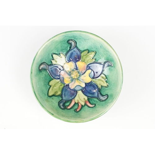 21 - Moorcroft Pottery dish in the Columbine pattern, 12cm diameter, stamped to base