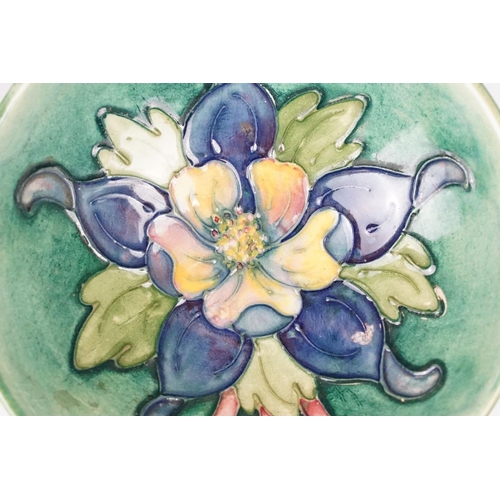 21 - Moorcroft Pottery dish in the Columbine pattern, 12cm diameter, stamped to base