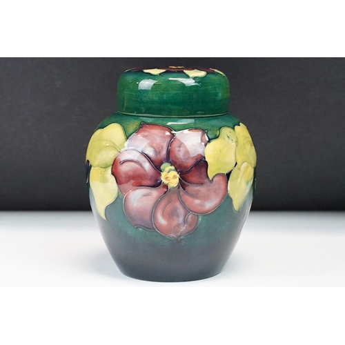 22 - Moorcroft pottery Clematis pattern ginger jar with typical tubelined floral decoration on green grou... 