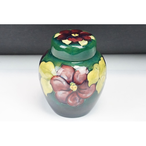 22 - Moorcroft pottery Clematis pattern ginger jar with typical tubelined floral decoration on green grou... 