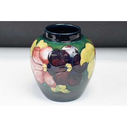 22 - Moorcroft pottery Clematis pattern ginger jar with typical tubelined floral decoration on green grou... 