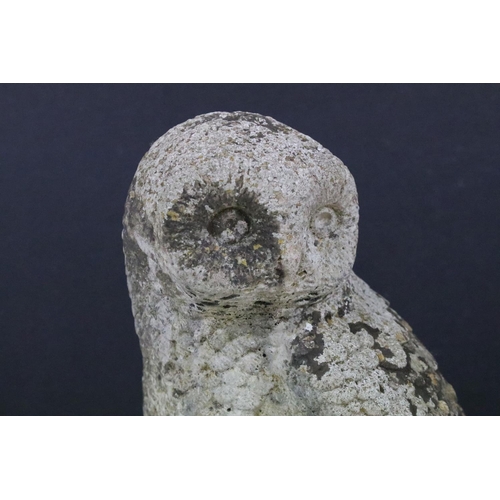 222 - A reconstituted stone garden ornament in the form of an owl, stands approx 38cm in height.