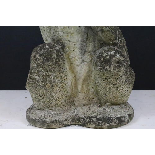 222 - A reconstituted stone garden ornament in the form of an owl, stands approx 38cm in height.