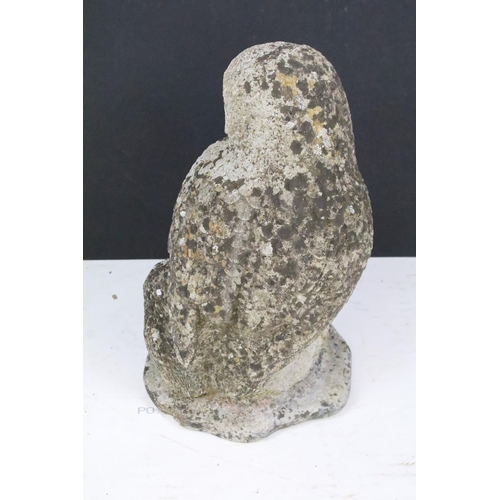 222 - A reconstituted stone garden ornament in the form of an owl, stands approx 38cm in height.