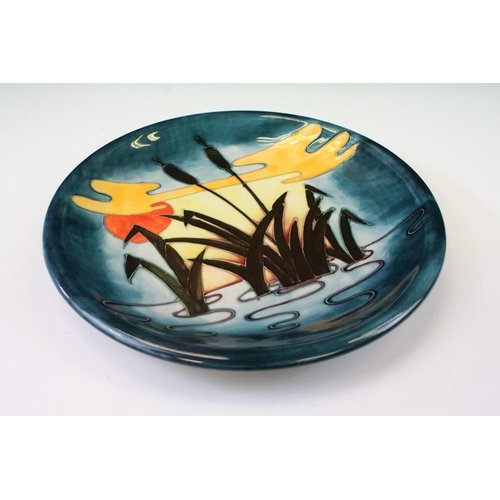 25 - Moorcroft Pottery Reeds at Sunset plate, with tube lined decoration, 26cm diameter, impressed mark t... 