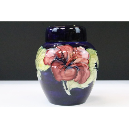 26 - Two Moorcroft pottery blue ground floral ginger jars to include a Hibiscus pattern and Anemone patte... 