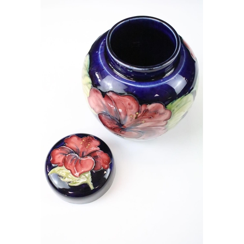 26 - Two Moorcroft pottery blue ground floral ginger jars to include a Hibiscus pattern and Anemone patte... 