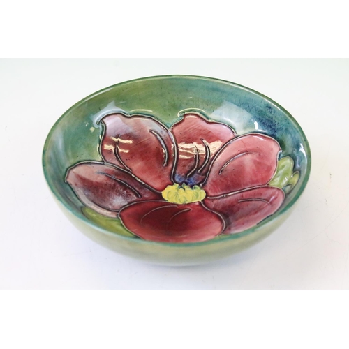 27 - Moorcroft Pottery footed dish in the Clematis pattern, green ground with pink/red, 14.5cm diameter, ... 