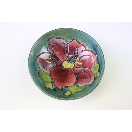 27 - Moorcroft Pottery footed dish in the Clematis pattern, green ground with pink/red, 14.5cm diameter, ... 