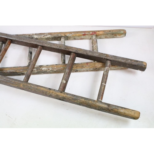 278 - Two mid 20th century wooden ladders, each standing approx 6ft in height.