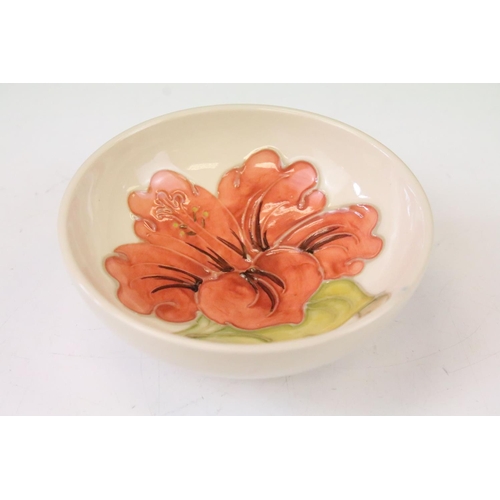 28 - Moorcroft pottery Hibiscus pattern circular bowl on cream ground, approx 11cm diameter, impressed ma... 