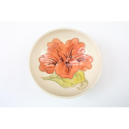 28 - Moorcroft pottery Hibiscus pattern circular bowl on cream ground, approx 11cm diameter, impressed ma... 