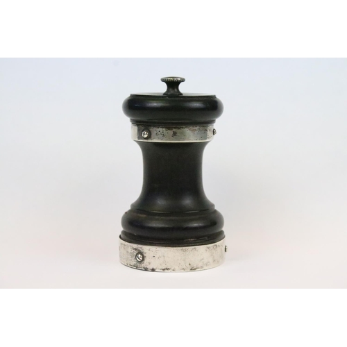 29 - An ebonised wooden pepper mill with fully hallmarked sterling silver collars, assay marked for Birmi... 