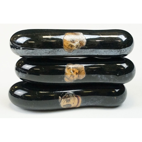 322 - A collection of ten black ceramic parasol handles with transfer decoration of dogs