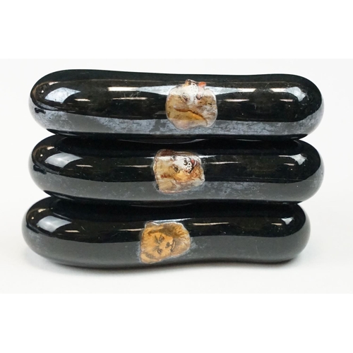 322 - A collection of ten black ceramic parasol handles with transfer decoration of dogs