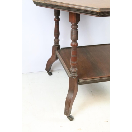 344 - Early 20th C table of hexagonal form on four turned legs, with lower central shelf, on brass casters... 