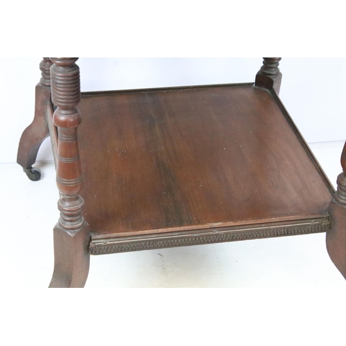 344 - Early 20th C table of hexagonal form on four turned legs, with lower central shelf, on brass casters... 