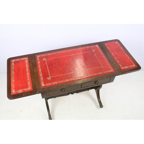 352 - Mahogany drop flap coffee table, with red leatherette inset top on lyre end supports, 56cm high x 10... 