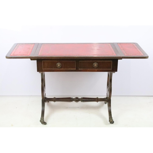 352 - Mahogany drop flap coffee table, with red leatherette inset top on lyre end supports, 56cm high x 10... 