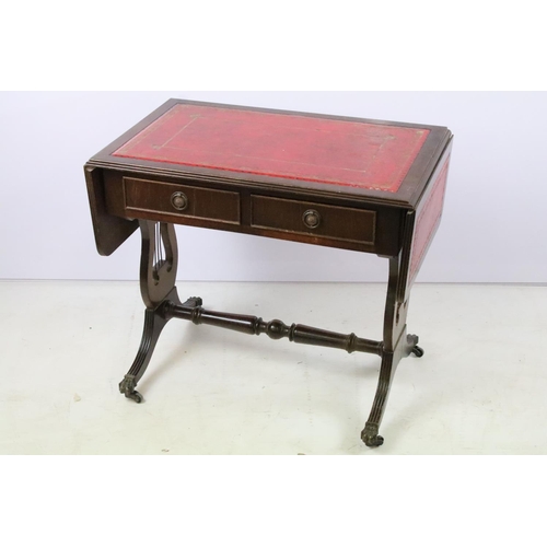 352 - Mahogany drop flap coffee table, with red leatherette inset top on lyre end supports, 56cm high x 10... 