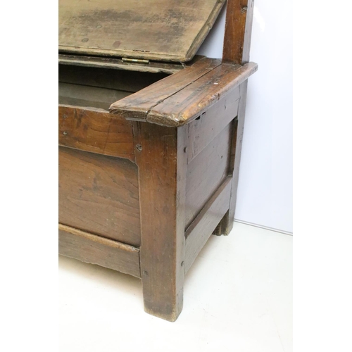 359 - 19th century oak bench / settle, the seat lids to reveal storage, with panelled front, 94cm high x 1... 