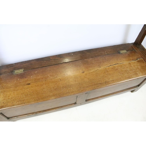 359 - 19th century oak bench / settle, the seat lids to reveal storage, with panelled front, 94cm high x 1... 