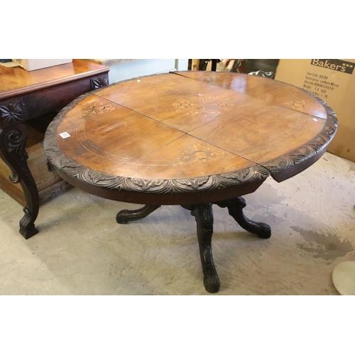 363 - Victorian walnut breakfast table, with marquetry inlay within carved borders on elaborately carved f... 