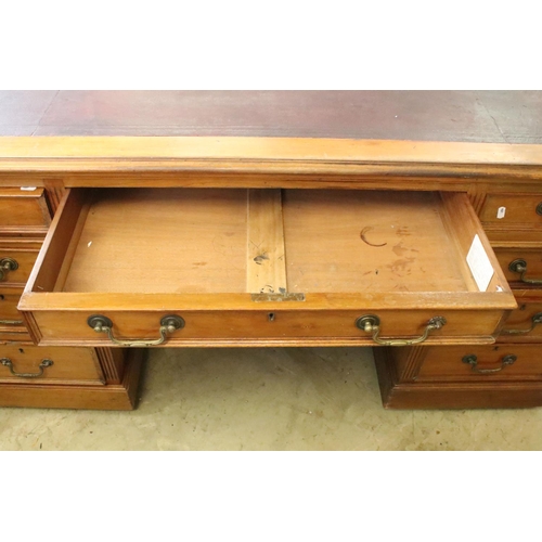 368 - Early 20th century mahogany twin pedestal desk with leatherette inset top, above an arrangement of n... 