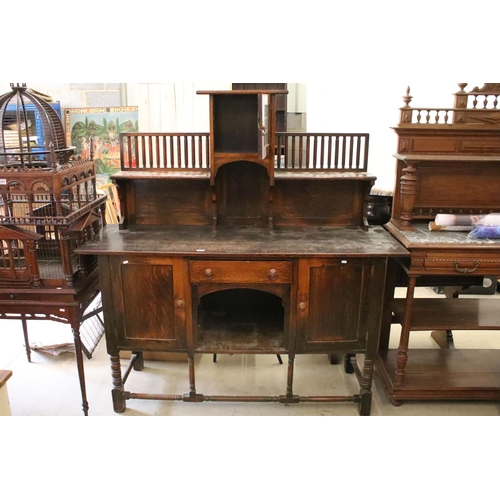 370 - Early 20th century oak sideboard, with lead glazed cupboard and shelves above central drawer, flanke... 