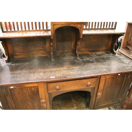 370 - Early 20th century oak sideboard, with lead glazed cupboard and shelves above central drawer, flanke... 