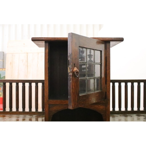 370 - Early 20th century oak sideboard, with lead glazed cupboard and shelves above central drawer, flanke... 